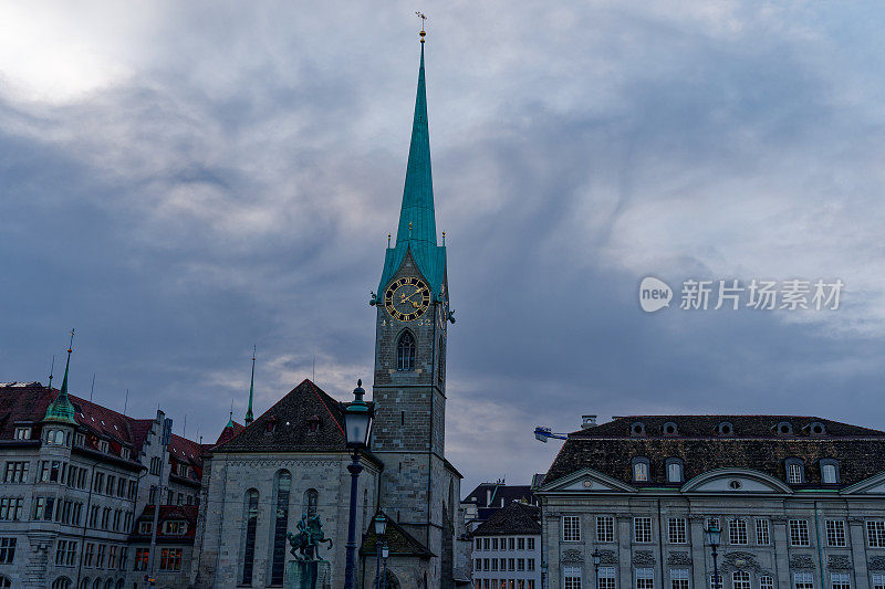 Famous church Women's Minster with rider sculpture  in the foreground at the old town of Zürich on a cloudy autumn late afternoon.
